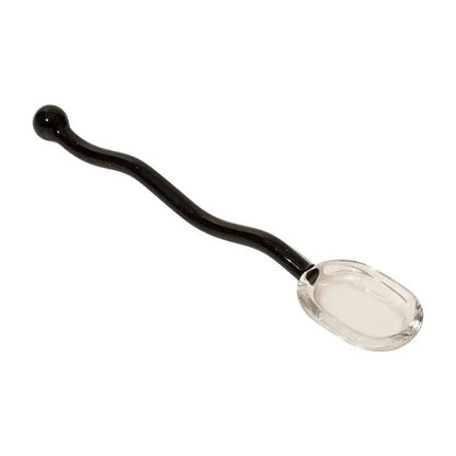 A sleek black glass spoon with a clear faceted bowl and curved handle for creative coffee and glass spoon dessert use