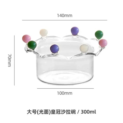 Clear glass fruit bowl with crown shaped rim featuring colorful glossy beads by decorbites for dining room decor