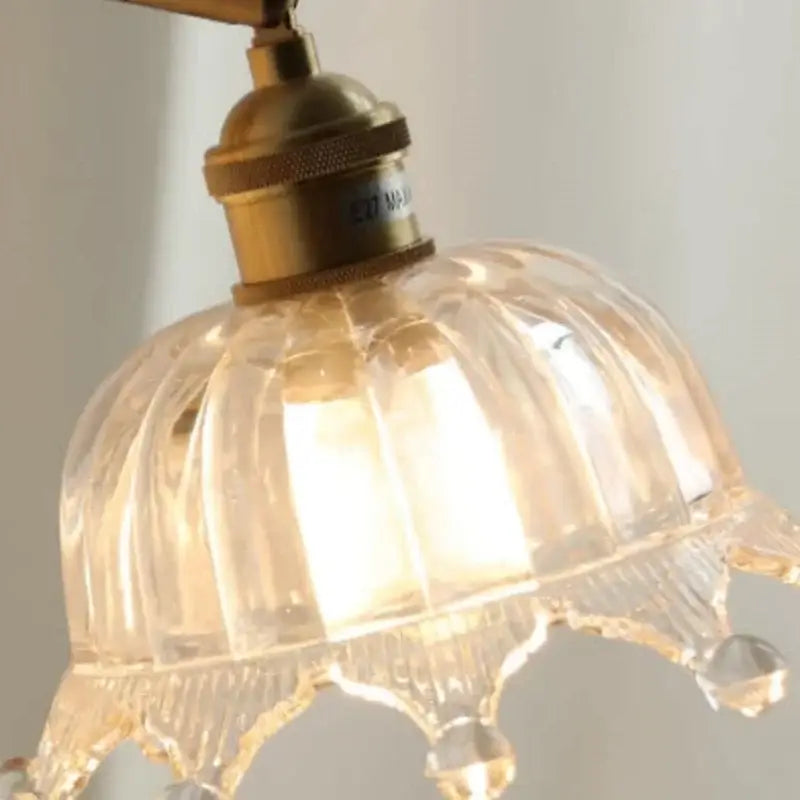 Clear ribbed glass led wall light with brass pull chain fixture featured in decorbites crown glass collection for bedroom decor