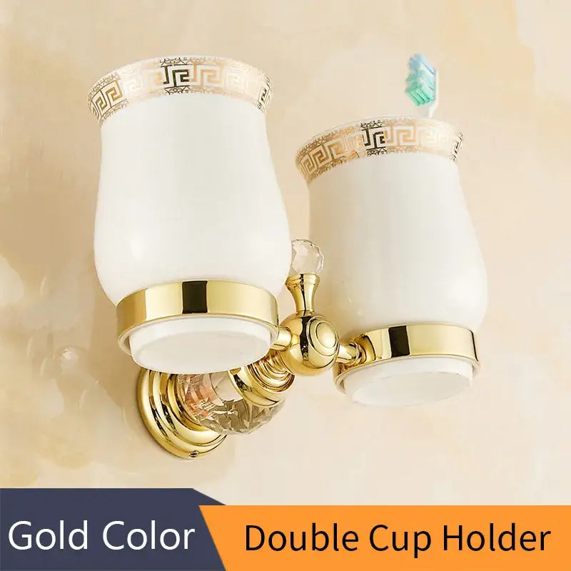 Gold-colored crystal brass gold double cup holder with white ceramic cups and gold greek key trim for brass gold bathroom decorbites crystal brass accessory