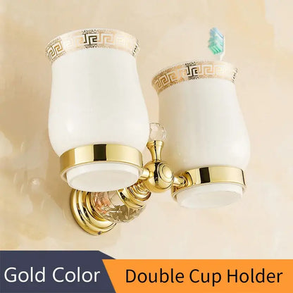 Gold-colored crystal brass gold double cup holder with white ceramic cups and gold greek key trim for brass gold bathroom decorbites crystal brass accessory