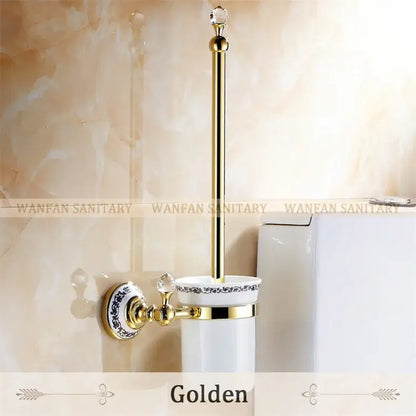 Golden toilet brush holder with polished brass gold finish and white ceramic cup with blue floral decorbites crystal brass