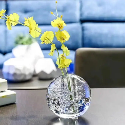 Clear spherical glass crystal bubble ball vase with vibrant yellow artificial flowers for decorbites desk decor