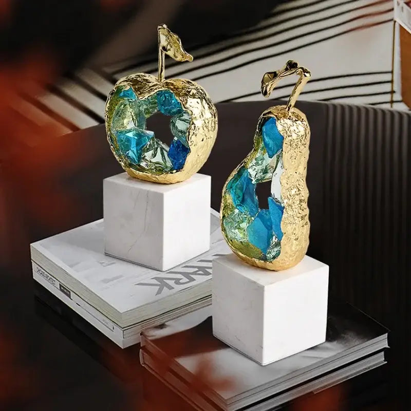 Golden apple and pear crystal fruit sculpture set with blue crystal interiors on white marble bases for living room decorbites crystal fruit