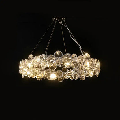 A modern circular pendant light with clear glass orbs in overlapping layers from decorbites crystal magic ring