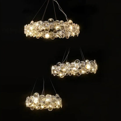 Three tiered decorbites crystal magic ring pendant light with clear glass orbs refracting warm light for dining room decor