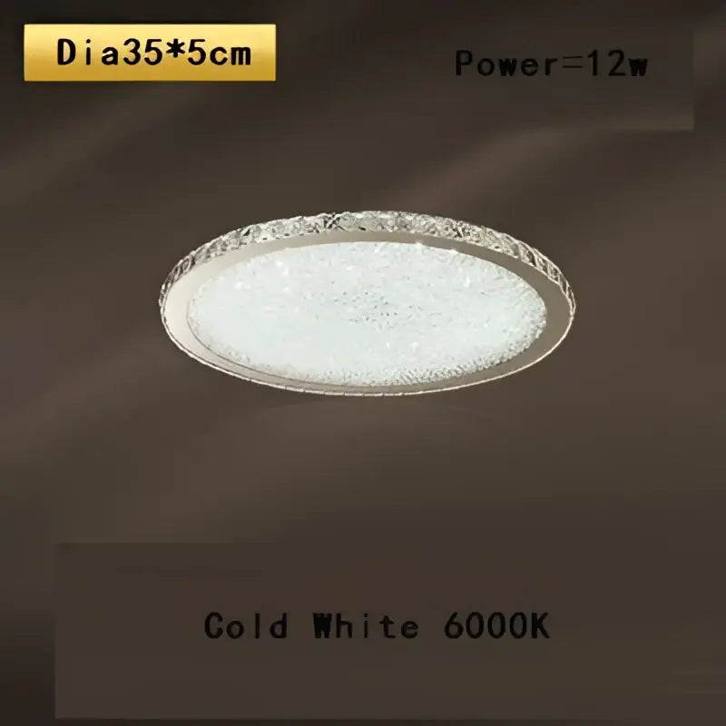 Crystal round ceiling lamp by decorbites with clear crystal-encrusted rim and frosted glass emitting cold white light
