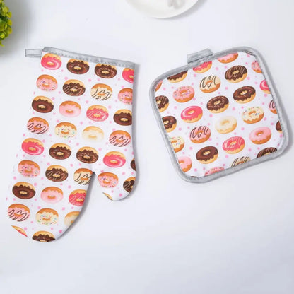 A decorbites cotton kitchen baking glove and pot holder set featuring donut-themed pink brown and white icing designs