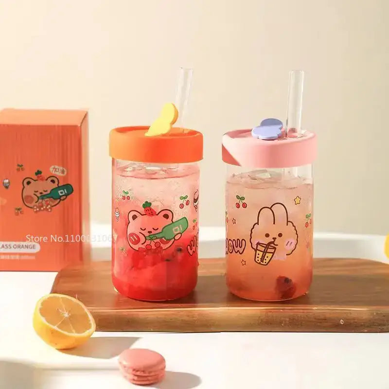 Two transparent glass cups with decorbites cartoon glass decals and orange pink silicone lids for kitchen drinkware