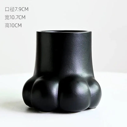 Black ceramic planter shaped like a cute cartoon cat paw print for living room decor vase set