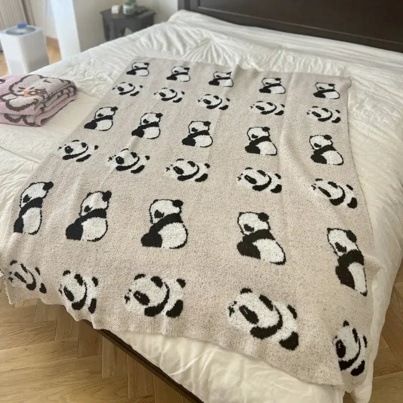 Cute cartoon pink and beige cat flannel blanket with a soft beige knit featuring black and white panda faces
