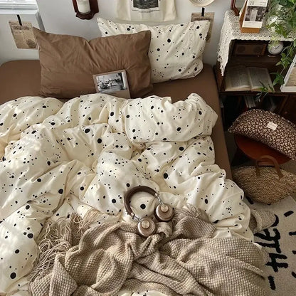 Cream-colored duvet cover with black polka dots in cute cartoon washed cotton bedding set with brown pillow and beige throw