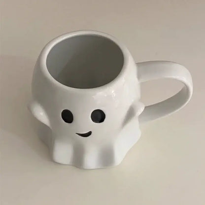 White ceramic mug in a decorbites cute ghost mug set featuring a smiling ghost with black eyes and curved mouth design