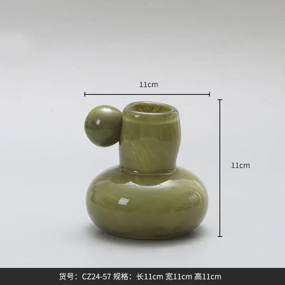 Olive-green ceramic candle holder with rounded base slender neck and spherical handle decorbites cute glass ball decor