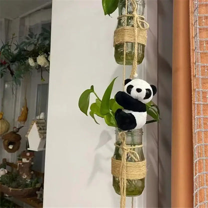 A cute panda plush black and white perched on a glass jar planter wrapped with natural twine decorbites cute panda decor