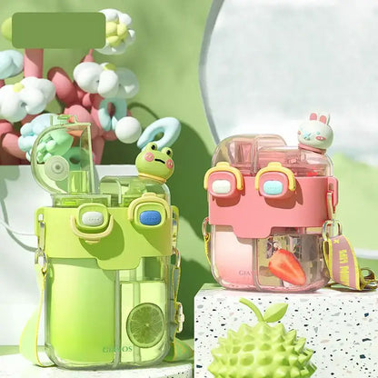 Lime green and pink pastel double-bin sippy cup with cute animal figurines on top for kids kitchen use