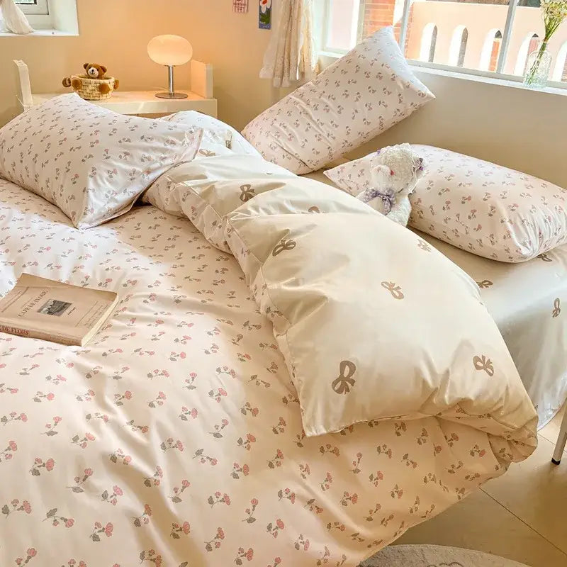 Cream-colored bedding set with delicate pink and green floral print on soft decorbites cotton fabric for bedroom decor