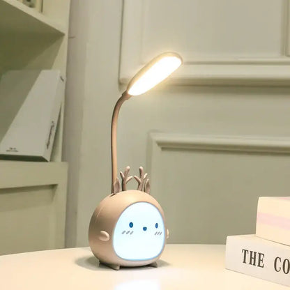 A beige cartoon deer led desk lamp with flexible neck and glowing light perfect as decorbites cartoon led night light