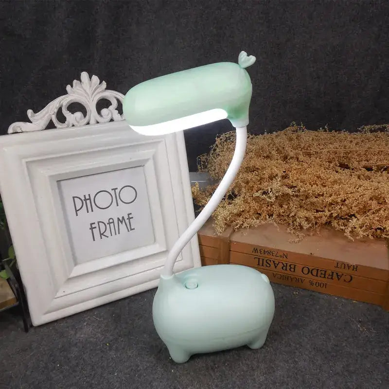 Mint green pig-shaped desk lamp with flexible neck and heart detail perfect for decorbites elk night lamp use