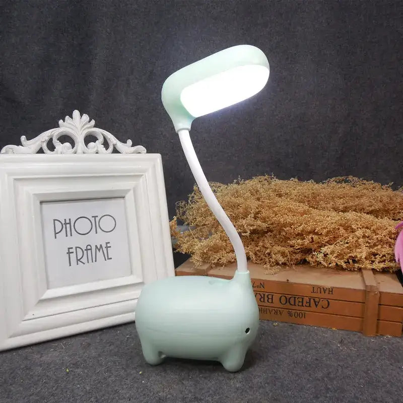 A mint green elephant-shaped led desk lamp with flexible neck and white base for decorbites elk night lamp decorbites elk