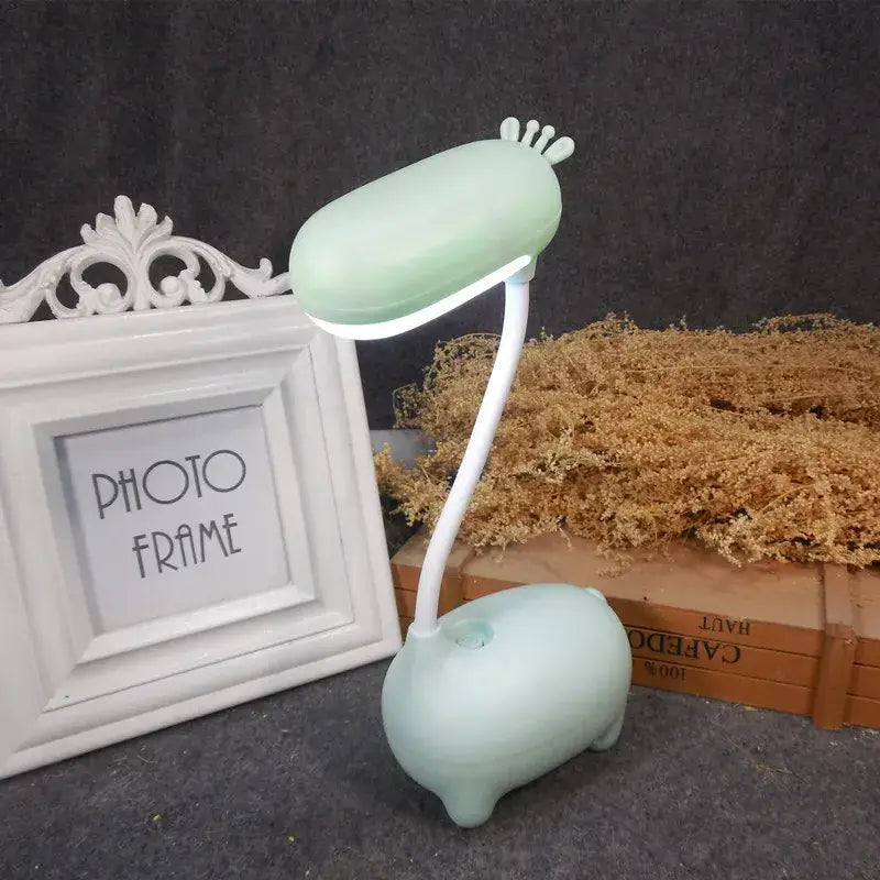 A mint green pig-shaped elk night lamp with flexible white neck for bedroom decorbites elk night lighting
