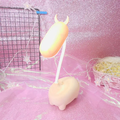 Pastel peach-colored soft plastic cute pig elk night lamp with small horns and flexible neck for desk decorbites elk night