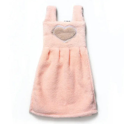 A soft pink terry cloth hand towel dress with a beige heart appliqué for cute cartoon hand towel kitchen decor