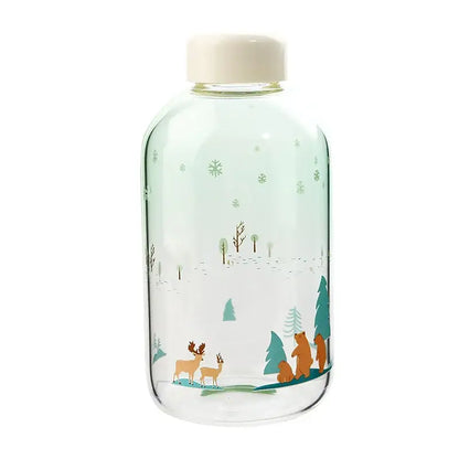 Clear glass water bottle with white cap featuring winter deer and bear design in soft teal for decorbites blue glass water