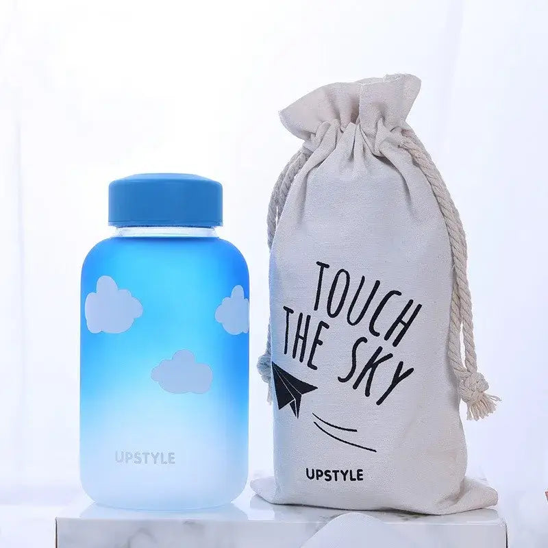 Blue glass water bottle with white cloud decals and upstyle lid from decorbites blue glass kitchen drinkware