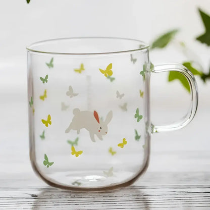 Clear glass coffee mug with heat resistant design featuring a white bunny with orange ears and butterflies