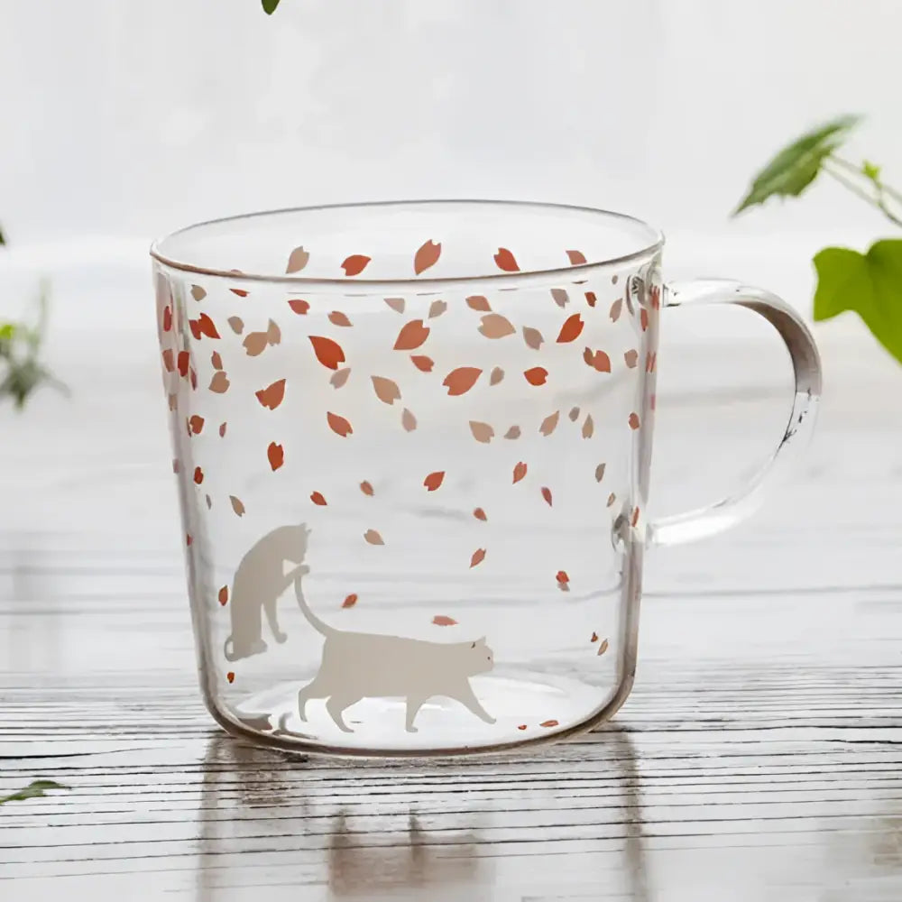 Clear glass coffee mug with orange and beige leaf patterns and cat silhouettes heat resistant for kitchen use