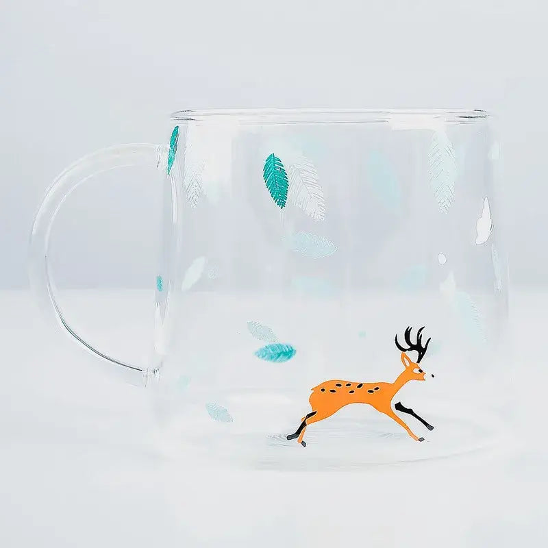 Clear glass coffee mug featuring a playful orange deer with black antlers and teal leaf decals for heat resistant use