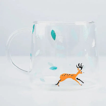 Clear glass coffee mug featuring a playful orange deer with black antlers and teal leaf decals for heat resistant use