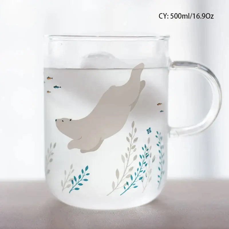 A clear frosted glass coffee mug with a beige seal and teal botanical design heat resistant for kitchen use
