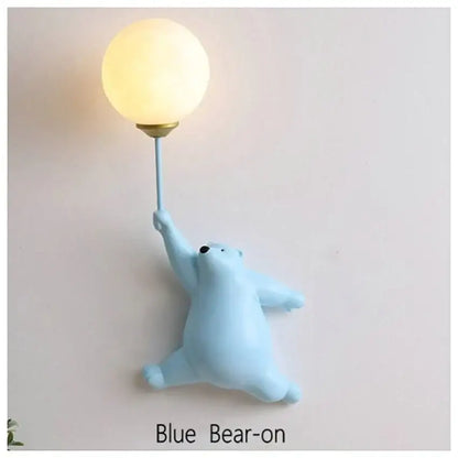 Light blue bear wall lamp holding a glowing spherical bulb ideal as a cute bedroom wall lamp accessory