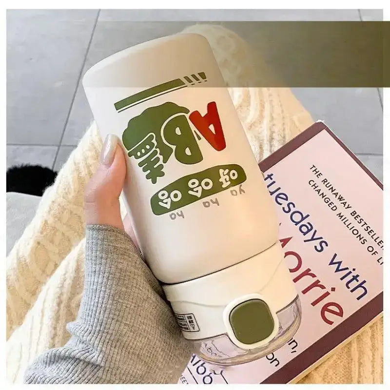 White insulated thermos cup with green and red decorbites cute straw cartoon design for kitchen and travel use