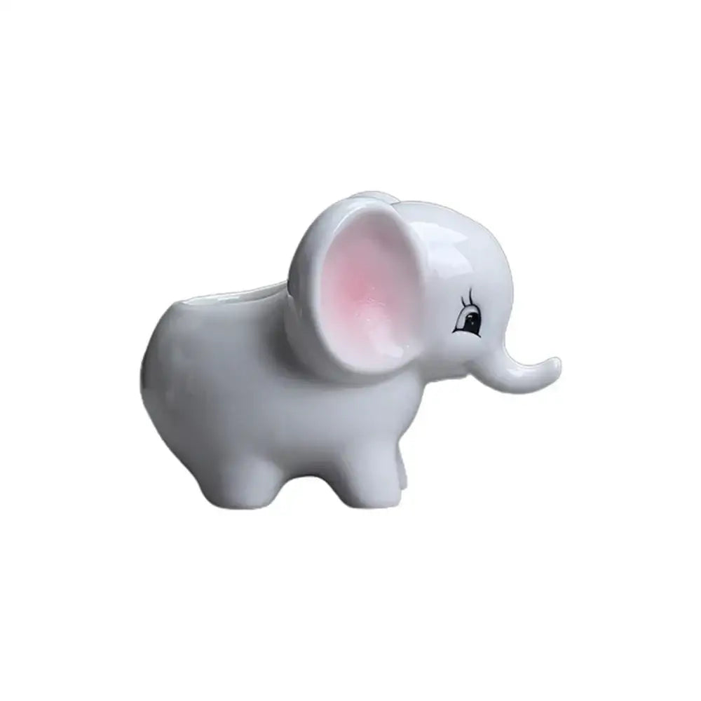 Glossy white ceramic elephant succulent planter with pink inner ears and cartoonish expression for bedroom decor