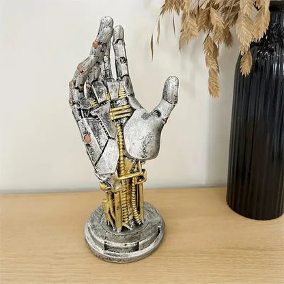 A detailed silver and gold mechanical arm desktop stand with visible joints and wires decorbites cyberpunk mechanical decor