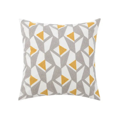 Square throw pillow with geometric embroidery of gray and mustard-yellow triangles on white decorbites daisy floral background