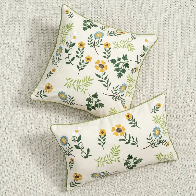 Cream-colored decorbites daisy floral cushion cover with green leaves embroidery and olive-green piping for living room decor