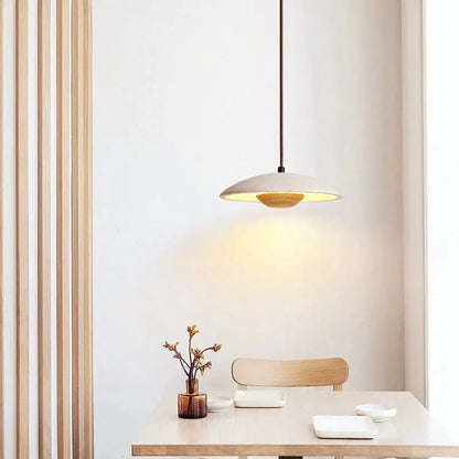 Minimalist cream stone pendant lamp with matte beige ceramic shade and warm glowing interior for bedroom decorbites cream stone