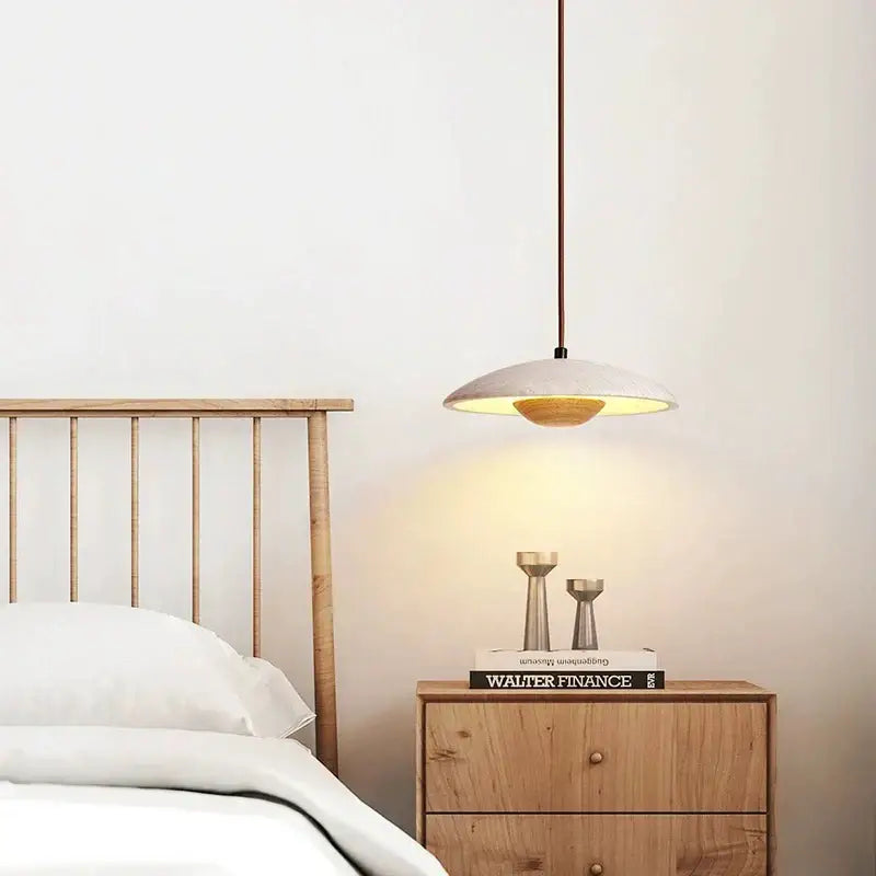Minimalist cream stone wood pendant lamp with a matte white disc shade and warm interior lighting for bedroom decorbites cream stone