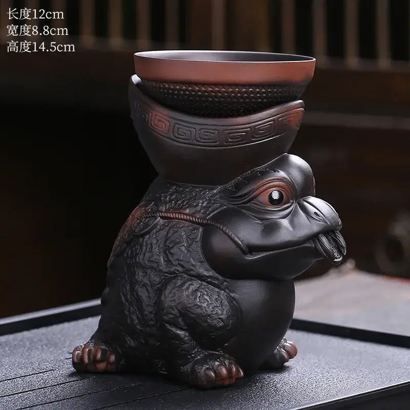 Black ceramic turtle figurine with glossy finish and reddish-brown accents used as a dragon tea leaf funnel filter decorbites dragon tea decor
