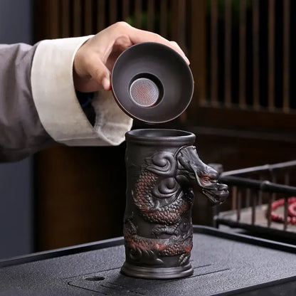 Dark brown ceramic dragon tea cup with intricate design and matching lid featuring funnel filter for decorbites dragon tea use