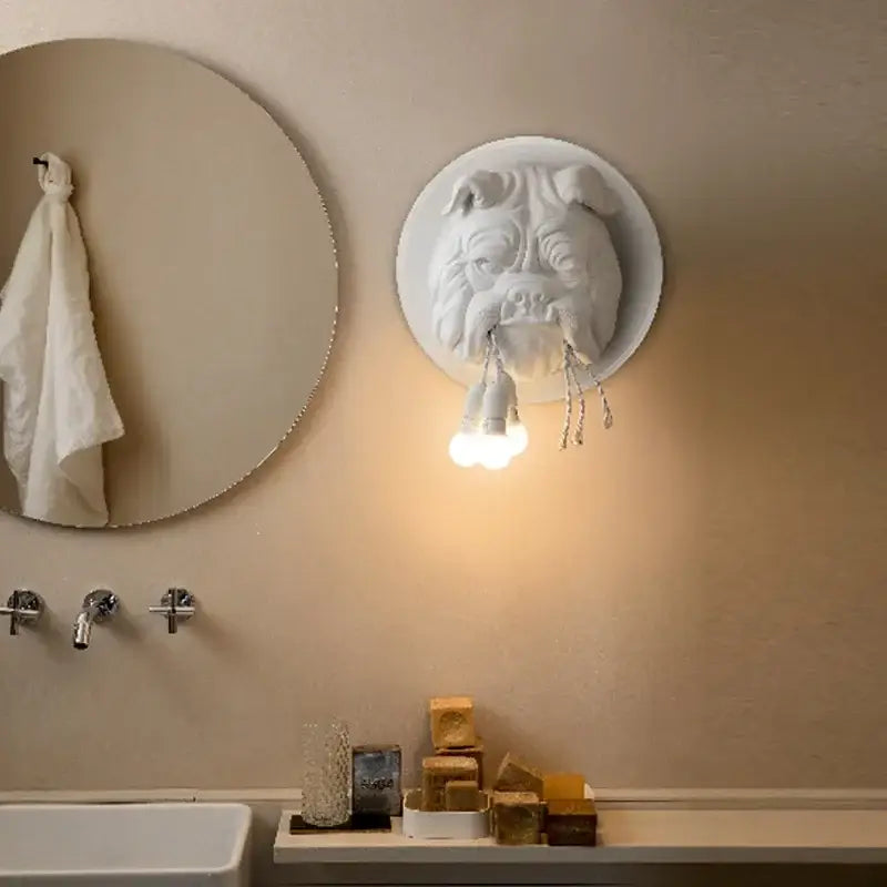 White sculpted decorbites bulldog resin wall lamp with three exposed bulbs hanging from mouth for living room decor
