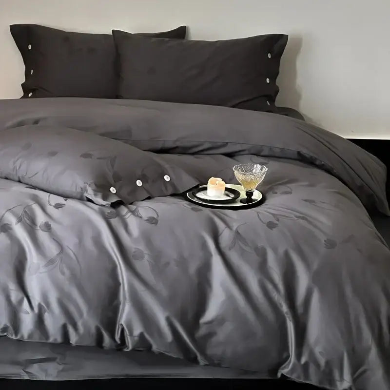 Dark gray egyptian cotton bedding set featuring satin-like fabric with floral embroidery and button detailing on pillowcases