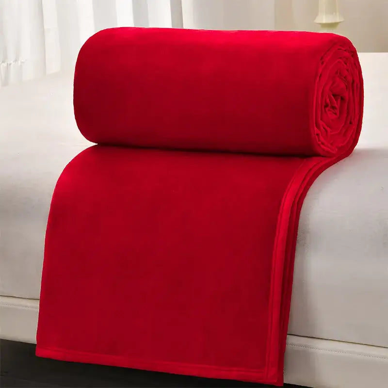 A plush vibrant red fleece blanket rolled neatly on white surface highlighting decorbites cozy flannel blanket quality