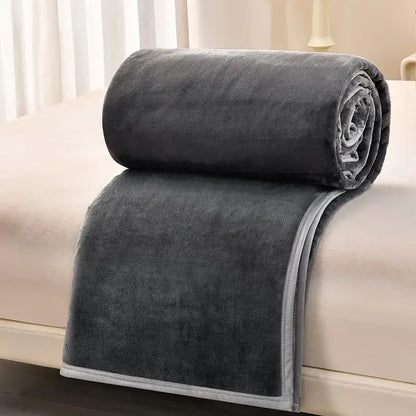 A dark gray decorbites cozy flannel blanket with light gray binding and soft velvety texture for living room sofa cover