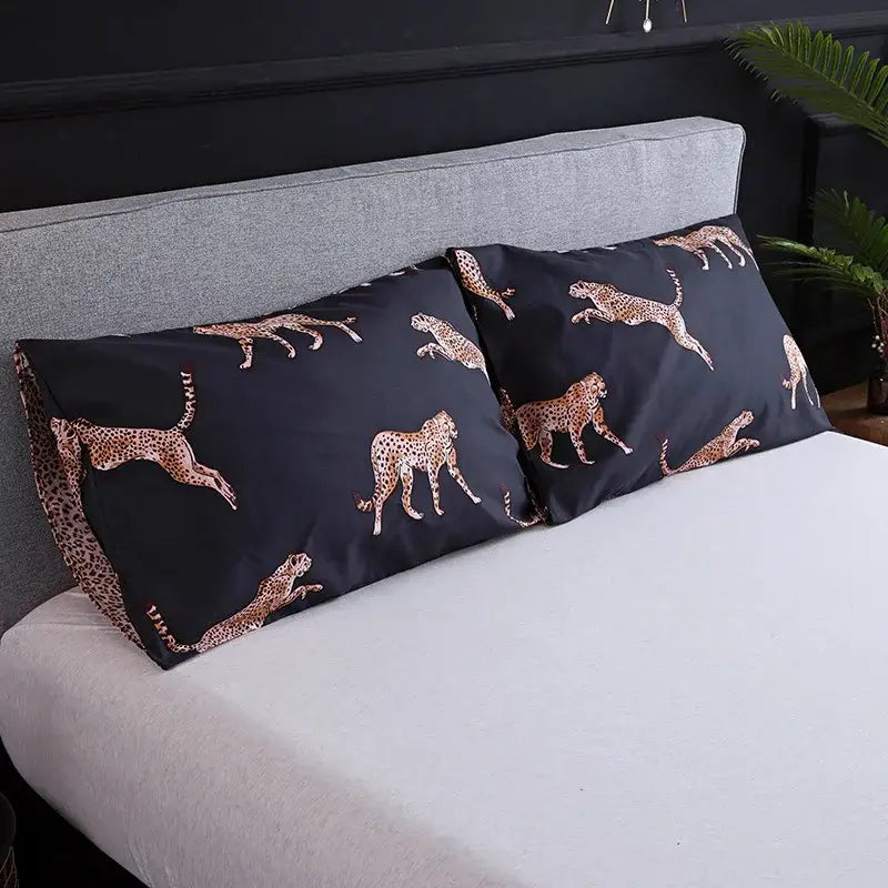 Black pillowcases with gold cheetah pattern complementing dark green floral plush duvet cover set for bedroom bedding