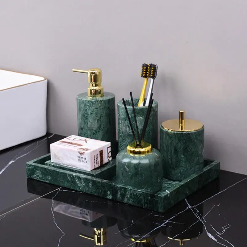 Dark green marble bathroom accessory set with gold accents from decorbites featuring green marble and metal details